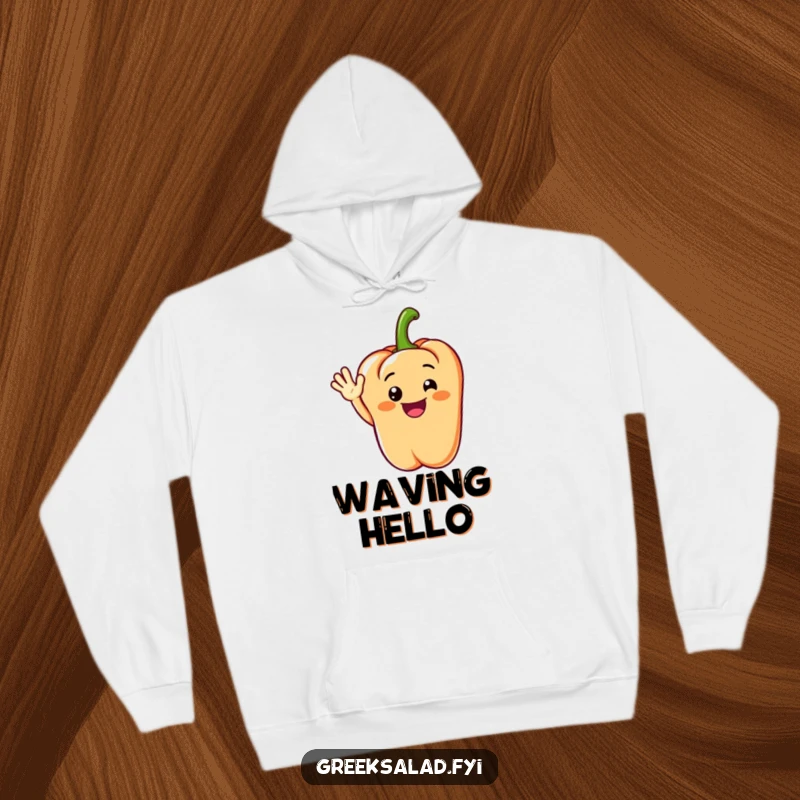 Funny hoodie depicting a grinning bell pepper segment performing a cheerful wave, perfect for warm and friendly occasions.